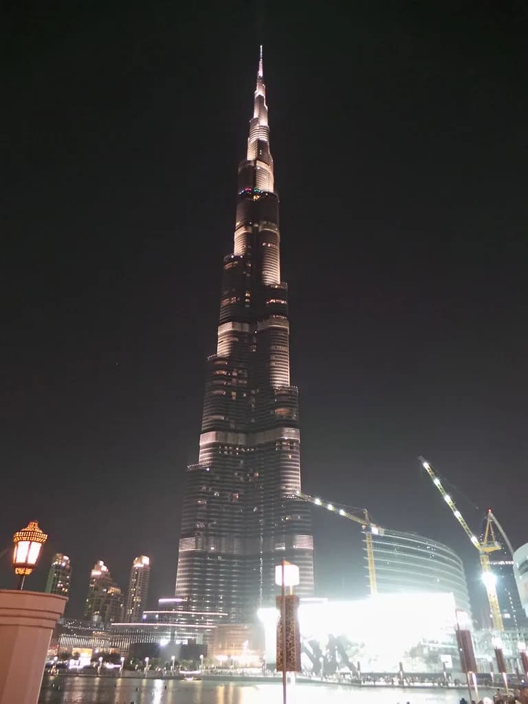 The Burj Khalifa lit at night above Downtown Dubai