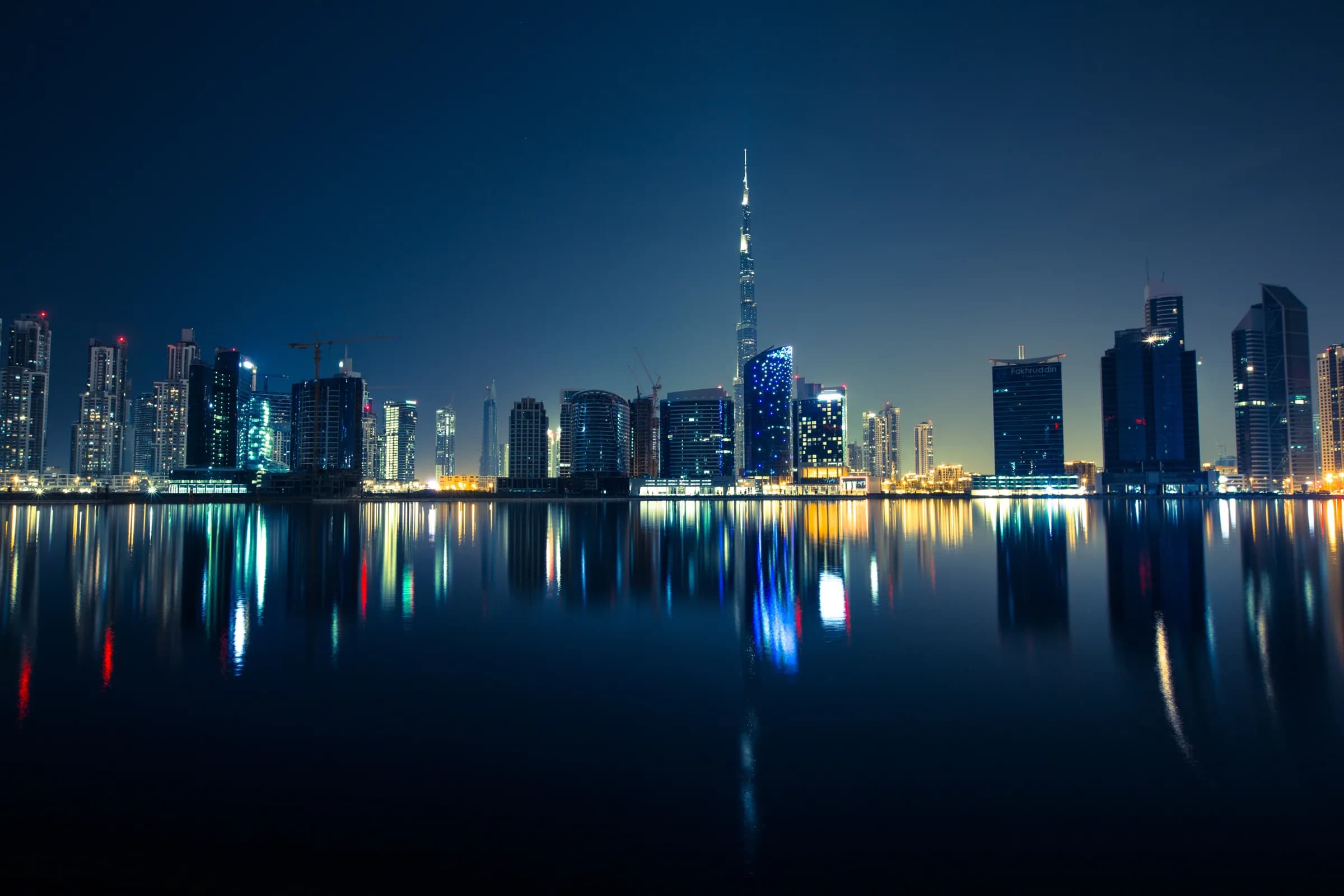 The Dubai skyline lit at night, the Burj Khalifa at its centre