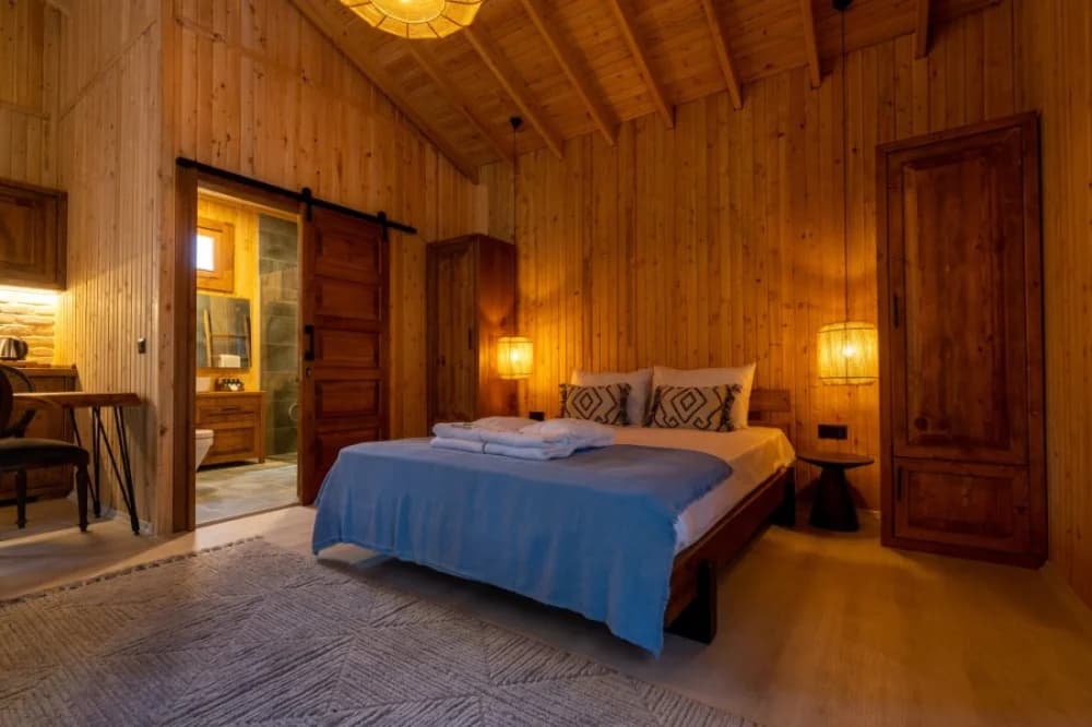 A timber-clad cabin bedroom at Naturelife