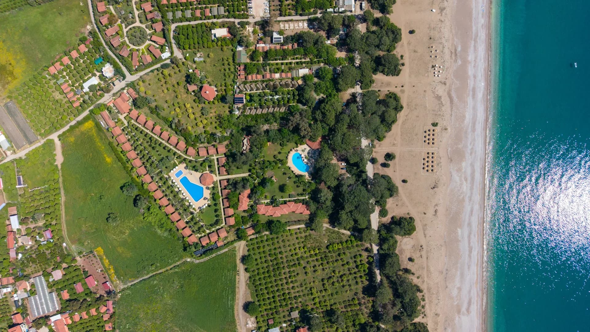Aerial view of Odile Hotel grounds meeting the Mediterranean beach
