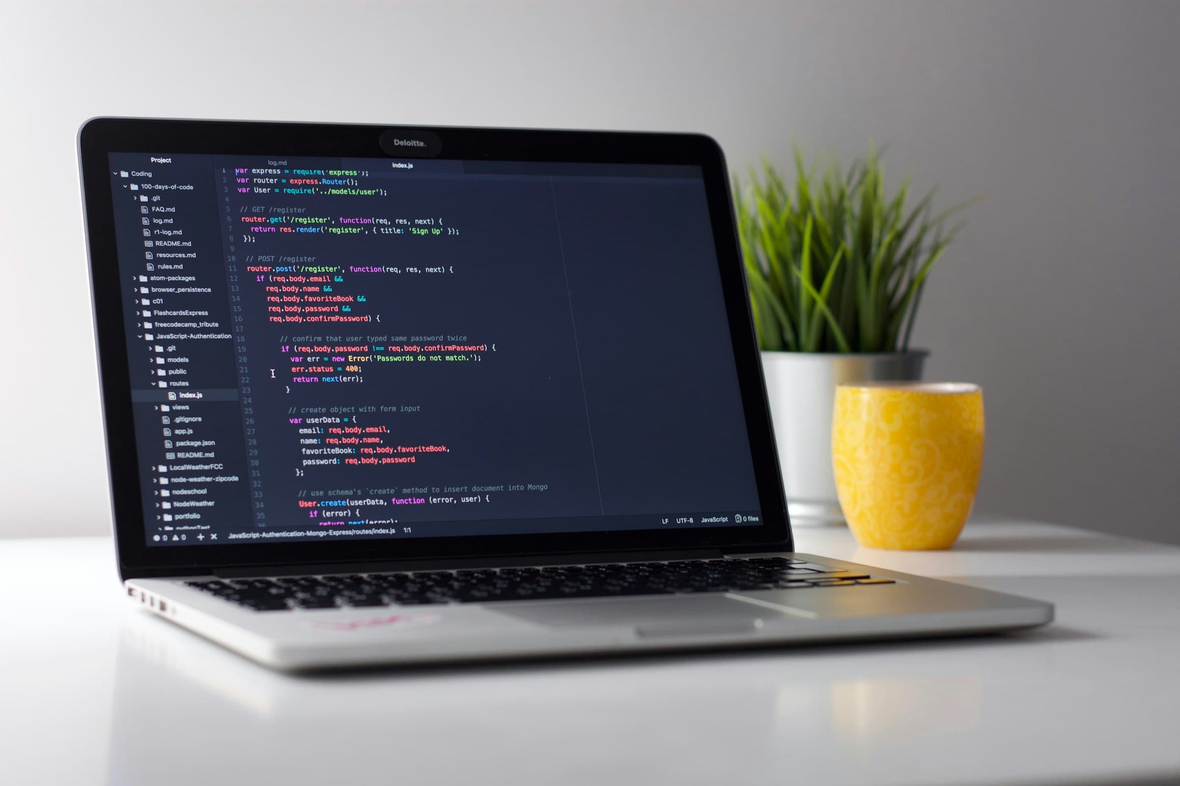 Developer workspace with multiple screens of code and neon syntax highlighting