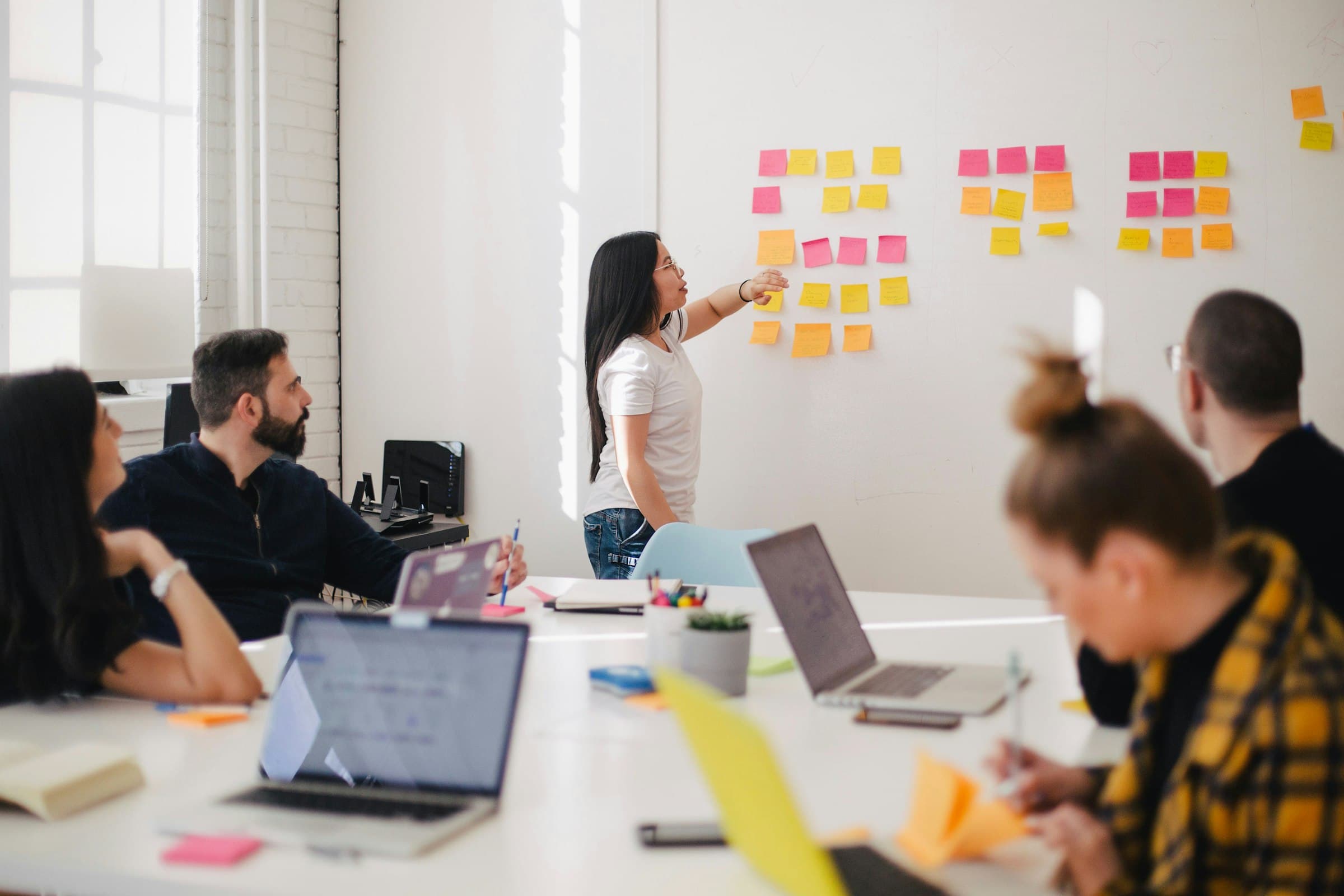 Diverse team collaborating around a table in a modern office workspace