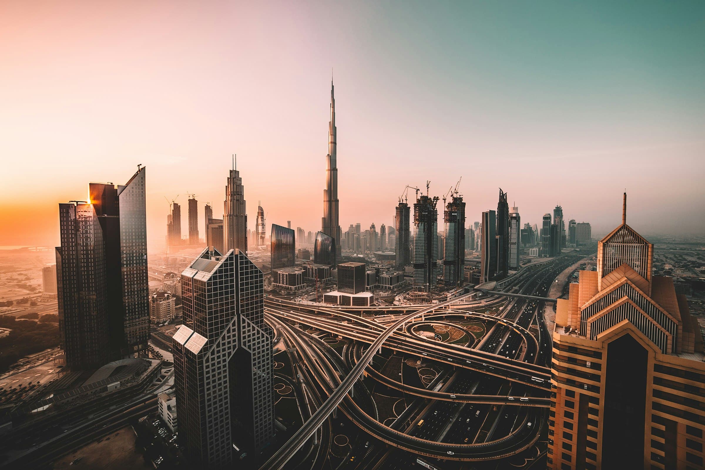 Aerial sunrise view of Dubai skyline with Burj Khalifa and downtown towers